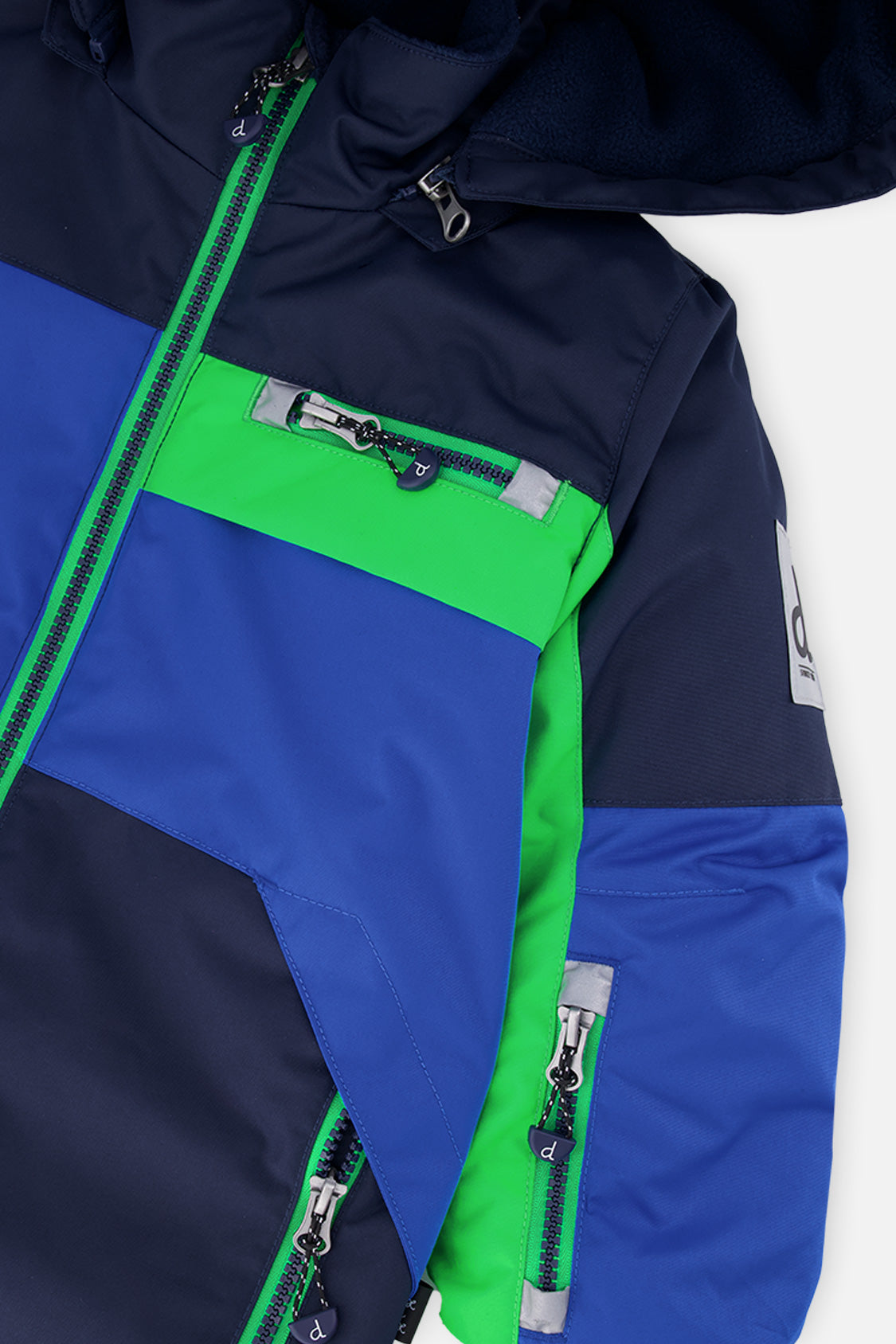 Close-up of the royal blue and green PLAY jacket front zipper, chest pocket and sleeve logo patch