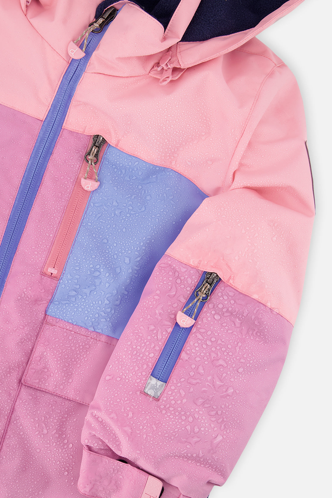 Close-up of the pink and purple colorblock PLAY jacket zipper and pockets