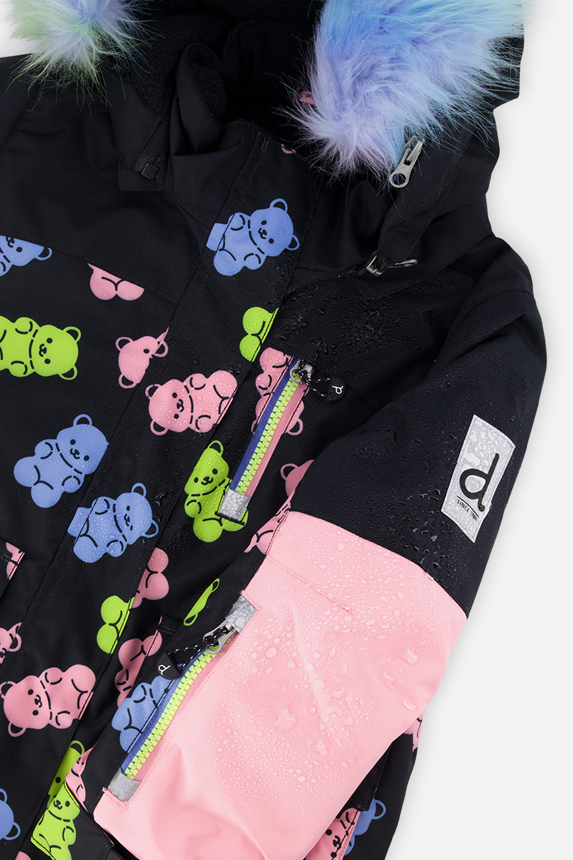 Close-up of the gummy bear print, pink sleeve and rainbow faux fur on the PLAY jacket