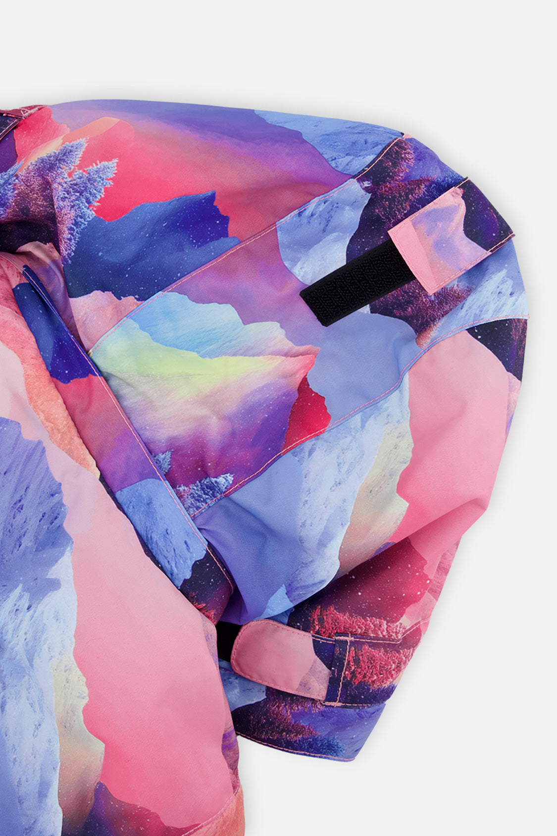 Close-up of the pink mountain-print hood and shoulder of the PLAY jacket