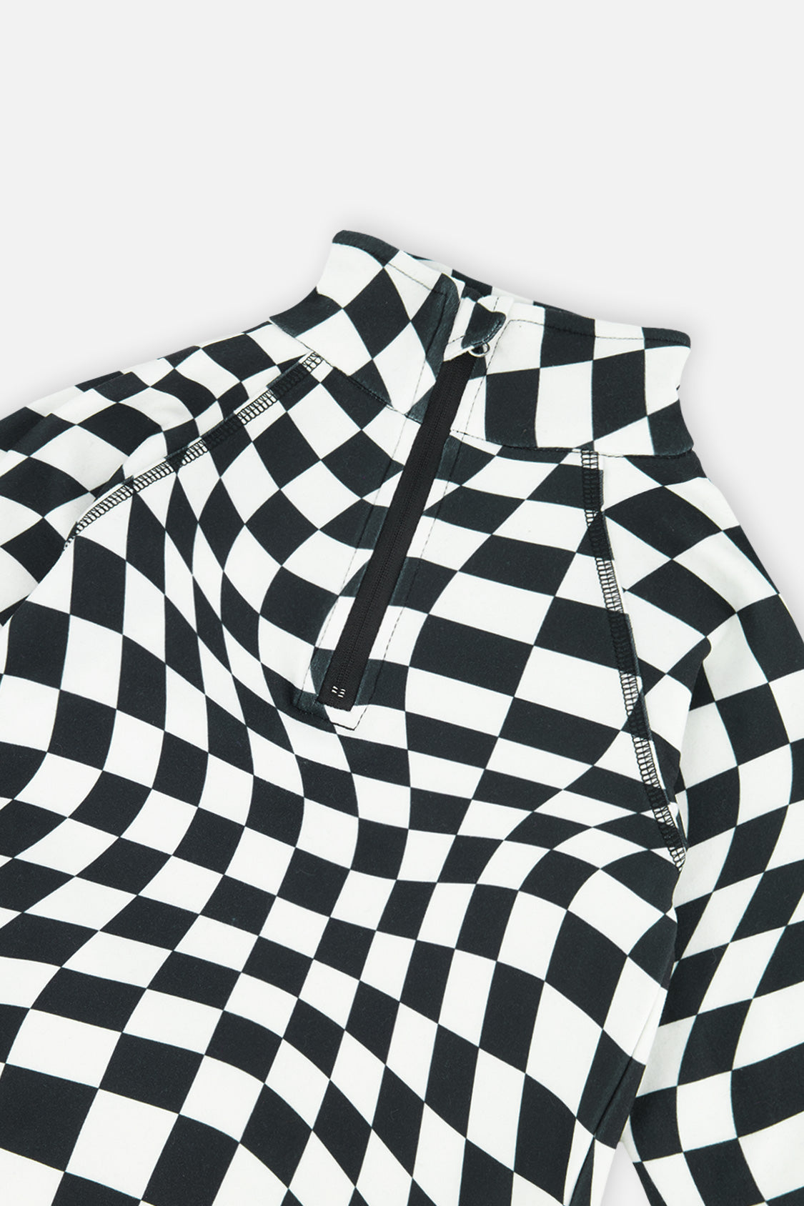 Close-up of the half-zip neck and wavy checkered print on the black and white Deux par Deux thermal underwear top