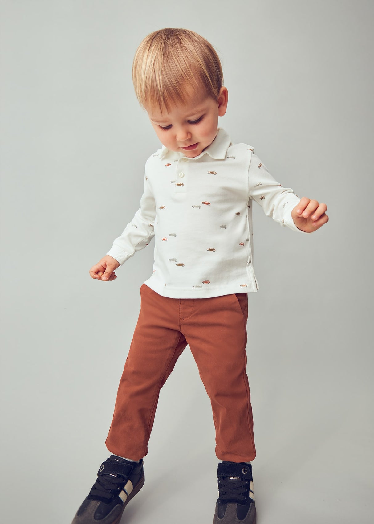 Toddler wearing slim-fit chinos showing adjustable waist and neat silhouette.