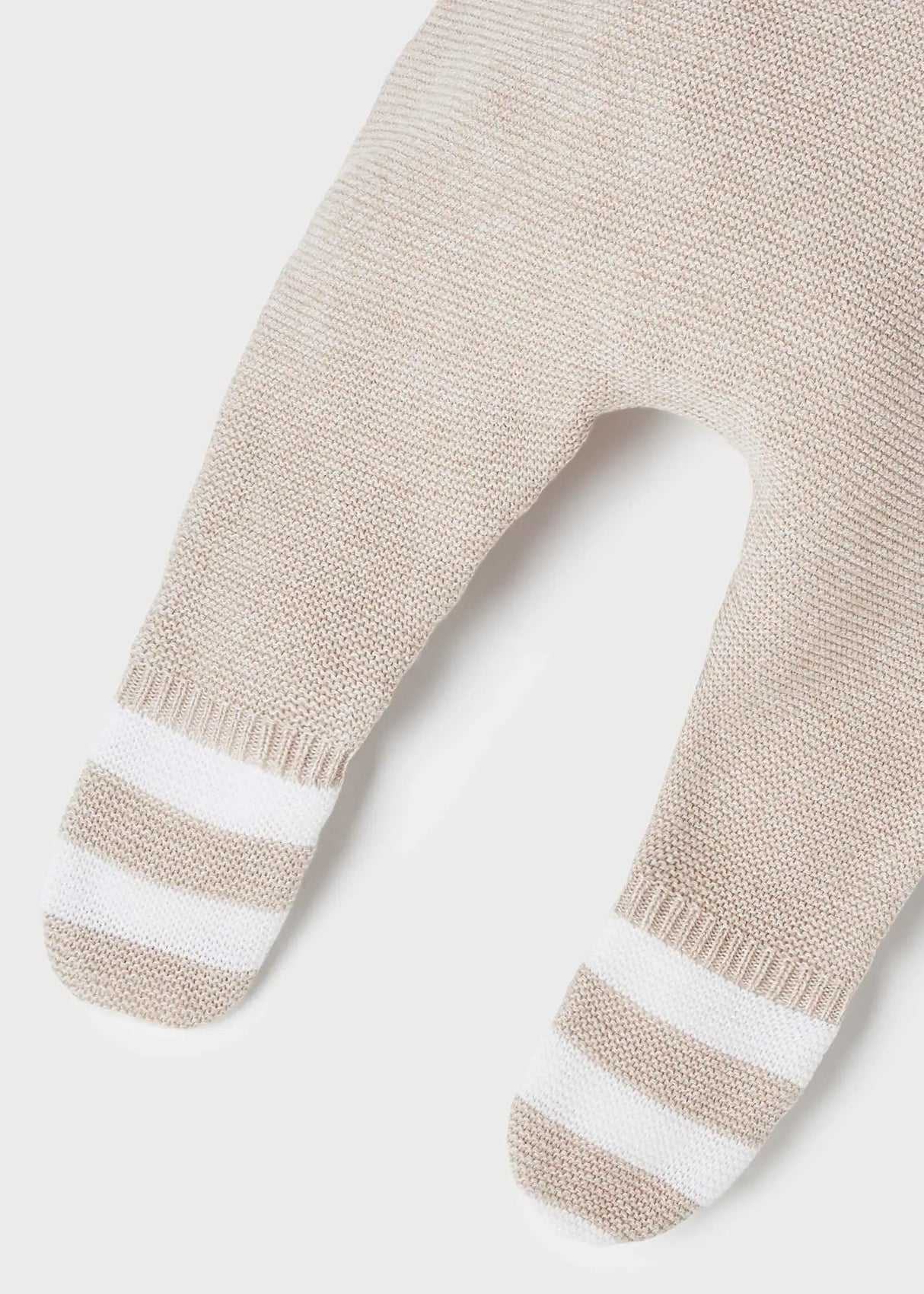 Detail of leg-warmer cuffs and elastic waistband on leggings.