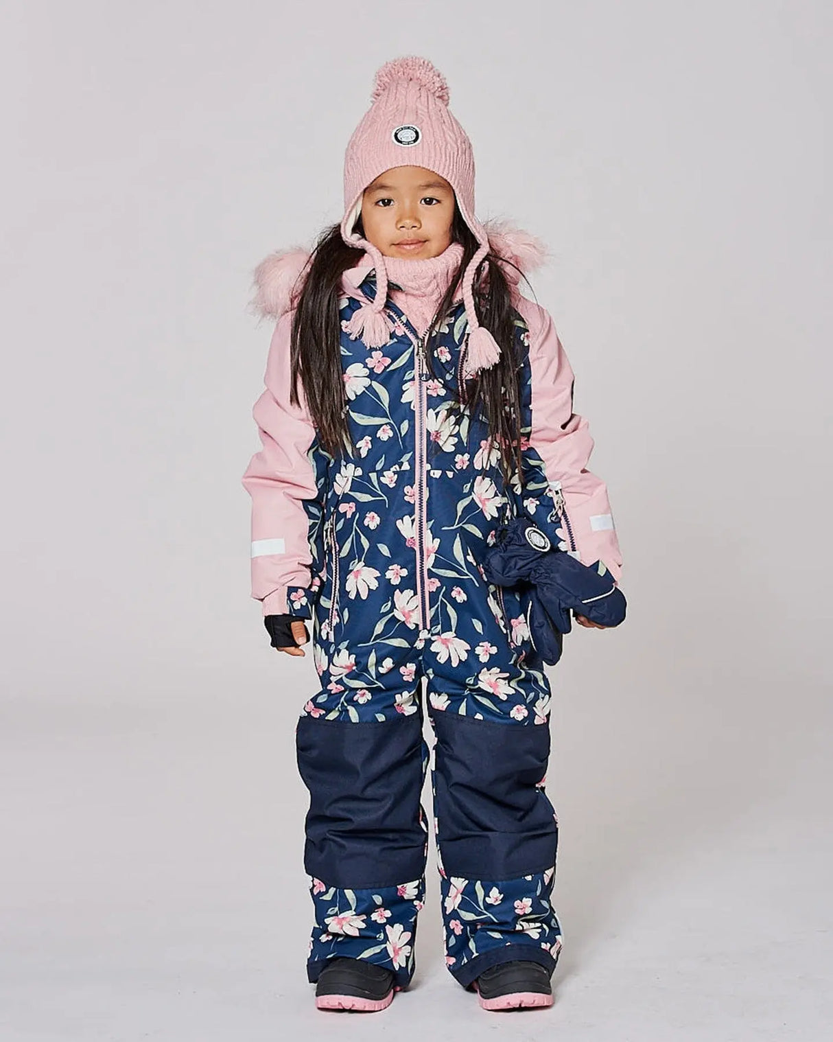 Side angle of navy flower print snowsuit showing articulated knees