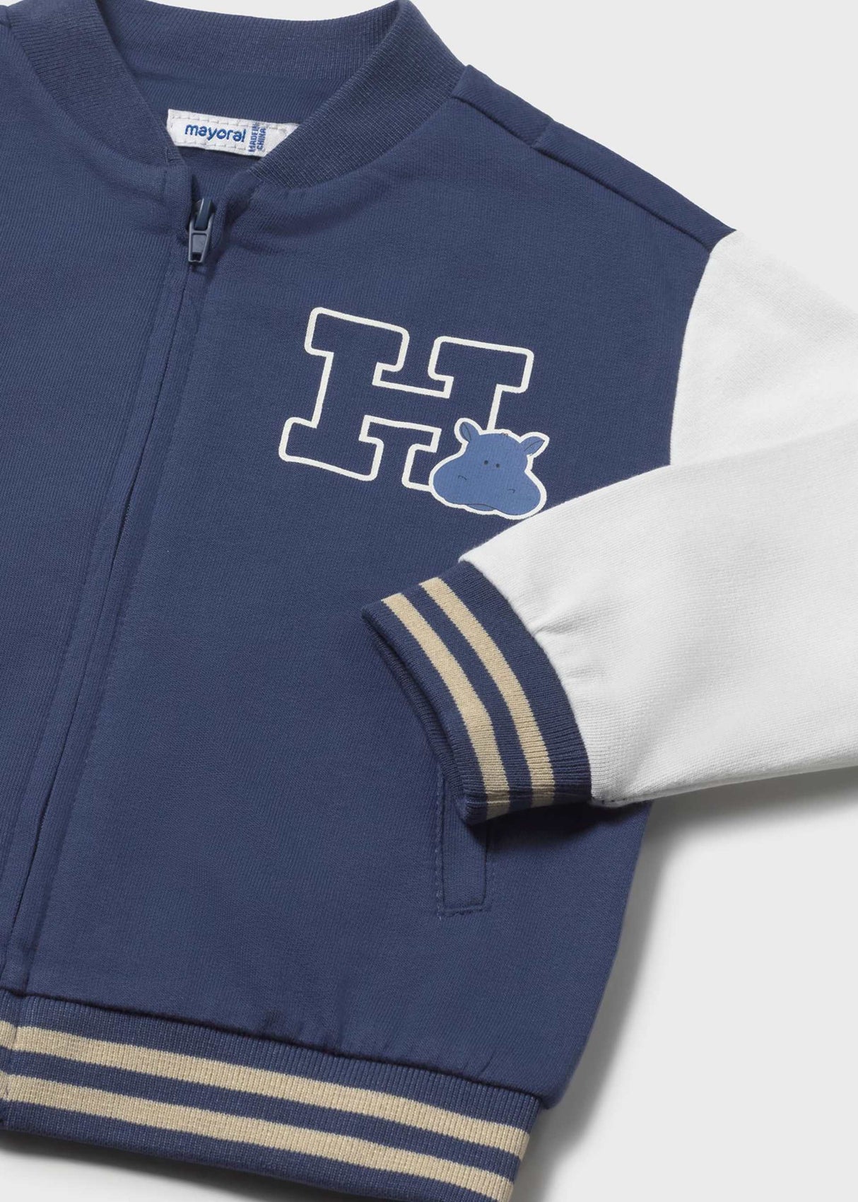 Closeup of Mayoral baby boy varsity jacket showing rib trim, patch detail, and zip front.