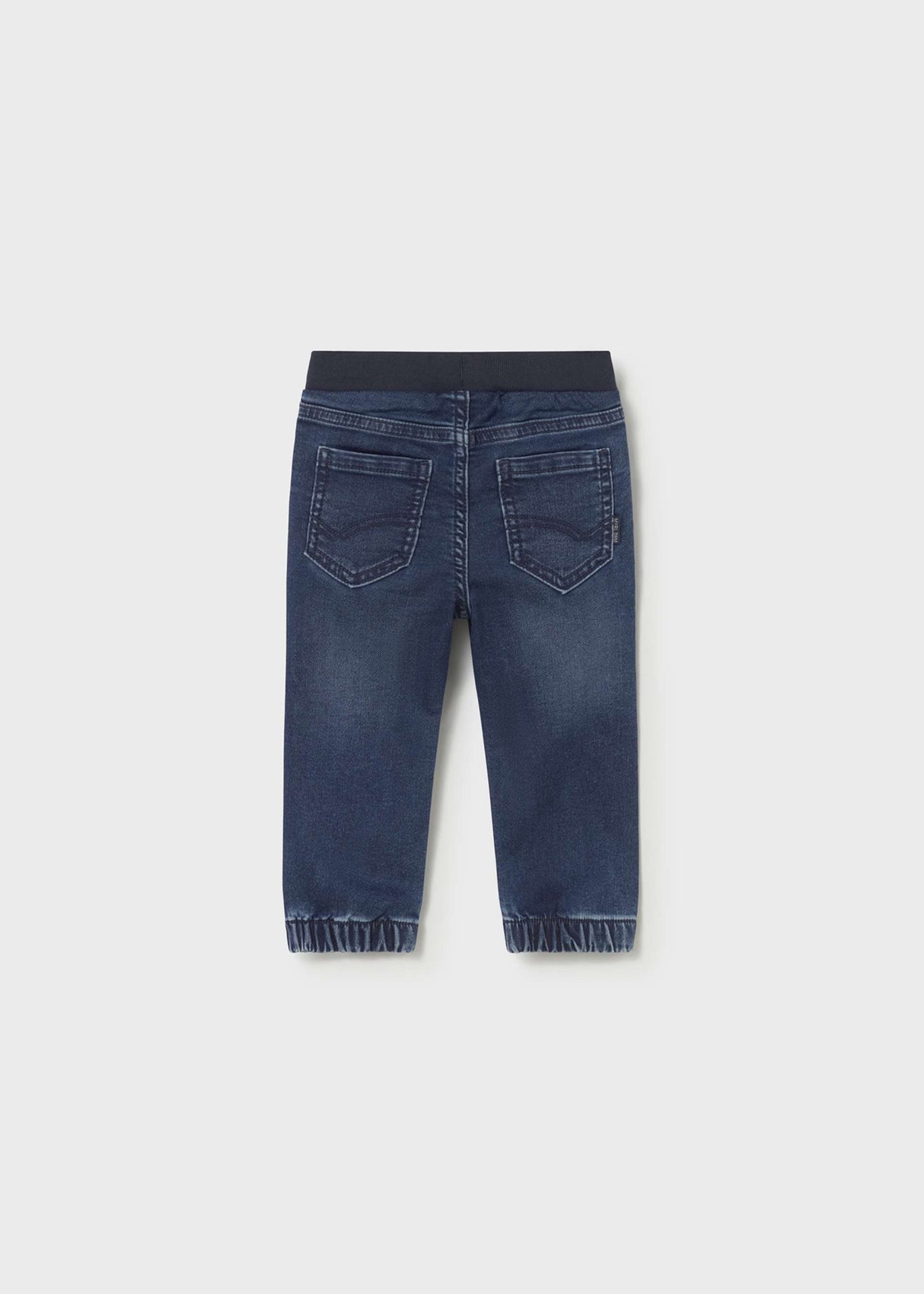 Back view of Mayoral baby boy jogger jeans showing Dark Blue denim wash and cuffed legs.