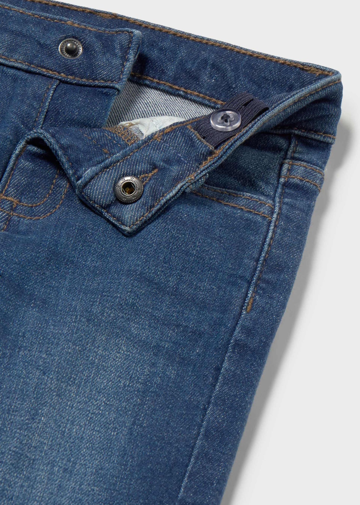 Close-up of Mayoral baby boy jeans showing Dark Blue denim wash, waistband, and button detail.