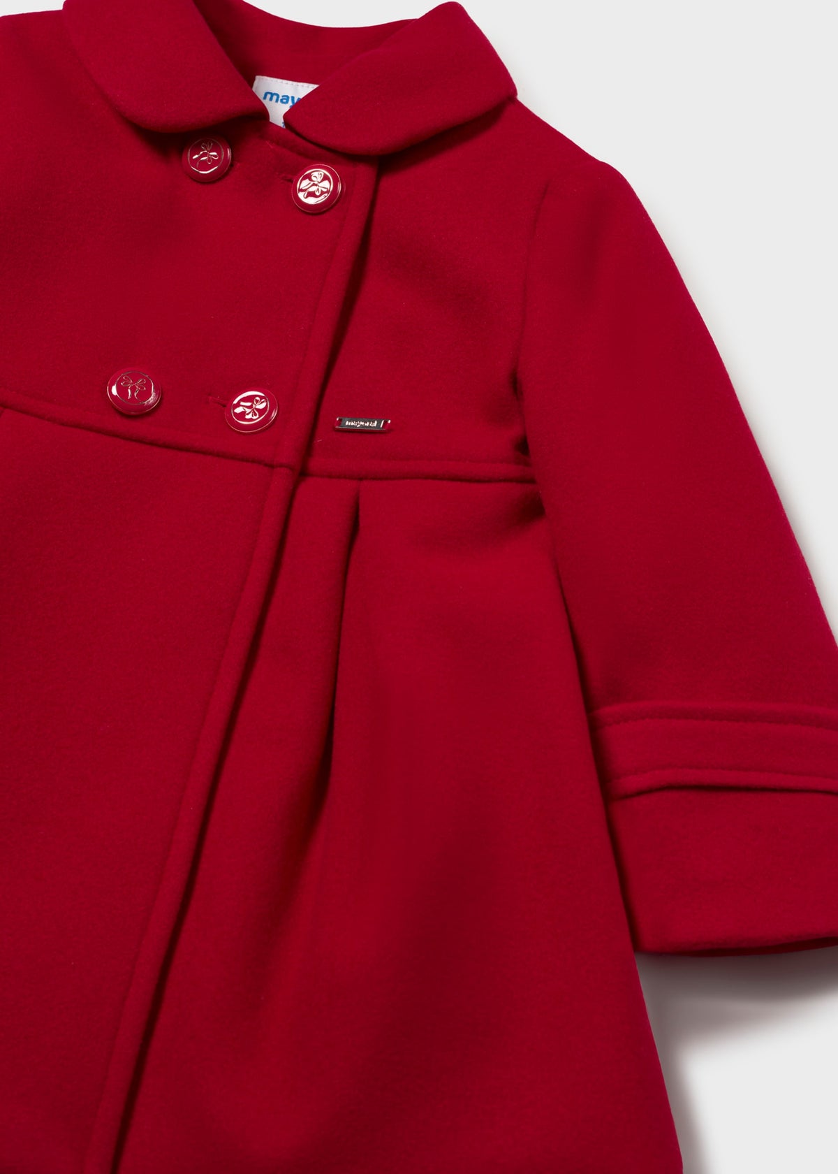 Close-up of four buttons and the round collar on the red double-breasted coat