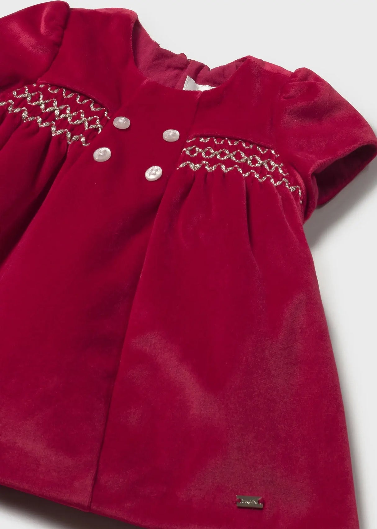 Close-up smocking on Mayoral newborn velvet dress red, elegant honeycomb design