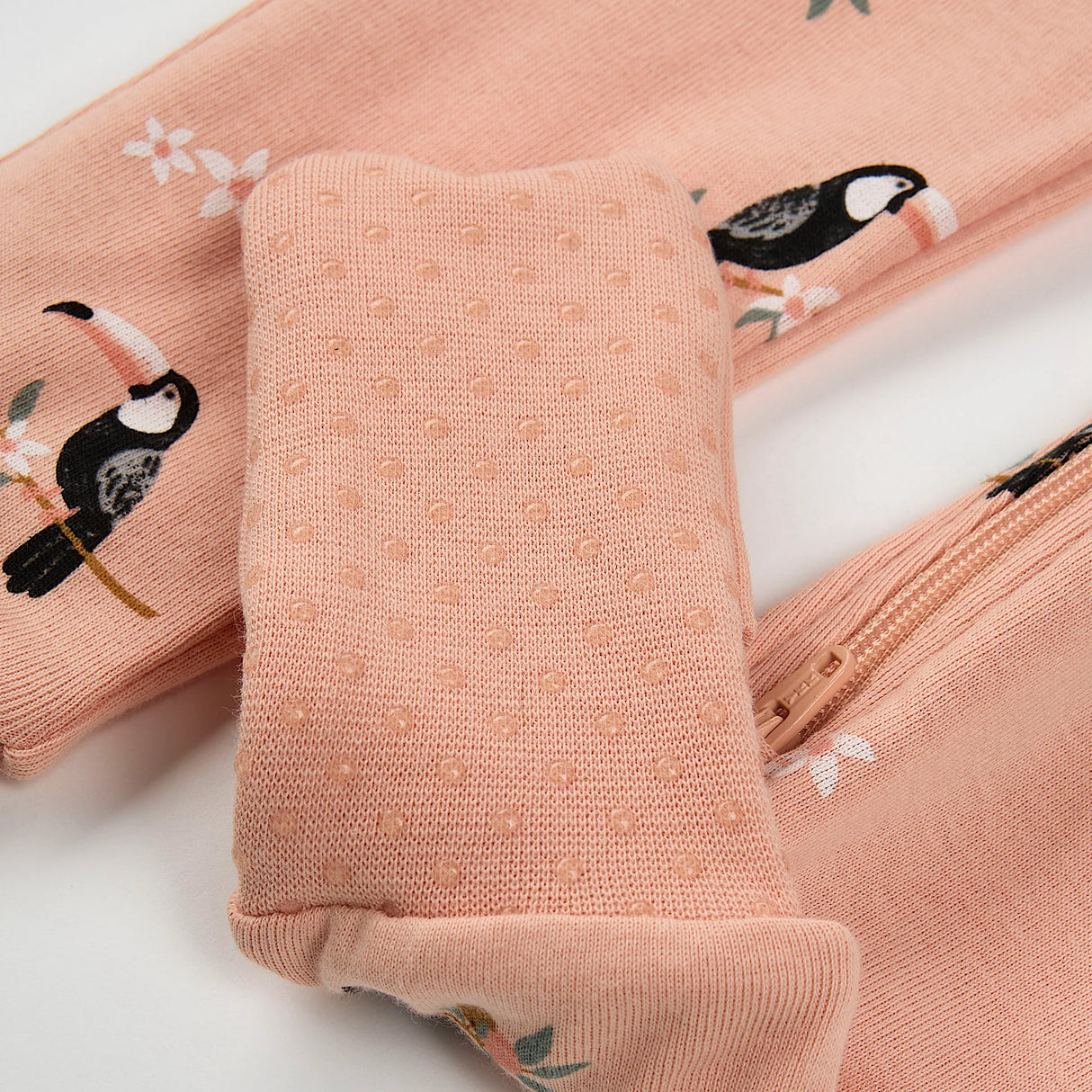 Close-up of ribbed cuffs and two-way zip on baby toucan convertible sleeper