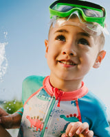 Close-up of zipper and neckline on grey baby dinosaur rashguard swimsuit