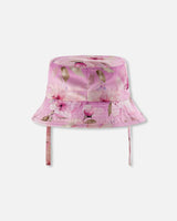 Side and back view of purple flower print beach hat showing brim shape and straps