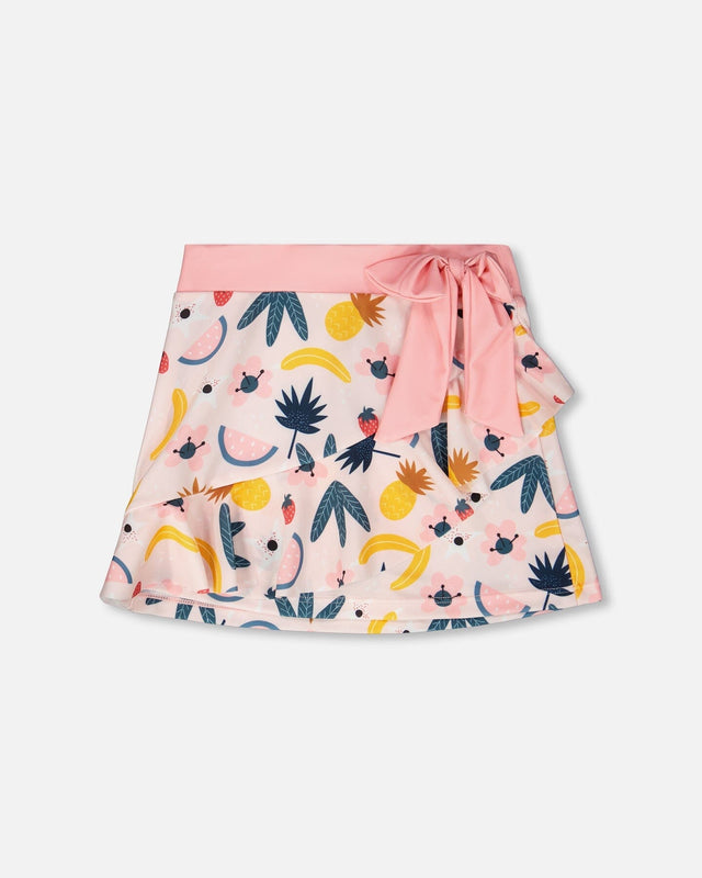 Flat lay of Deux par Deux girl pink printed fruits kids swim cover-up skirt with bow waist