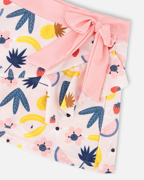 Close-up of waistband, bow, and fruit pattern on pink beach skirt cover-up for girls