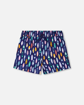 Front flat lay of Deux par Deux boy boardshorts in blue surfboard print