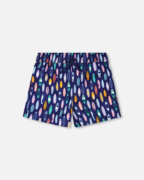 Front flat lay of Deux par Deux boy boardshorts in blue surfboard print