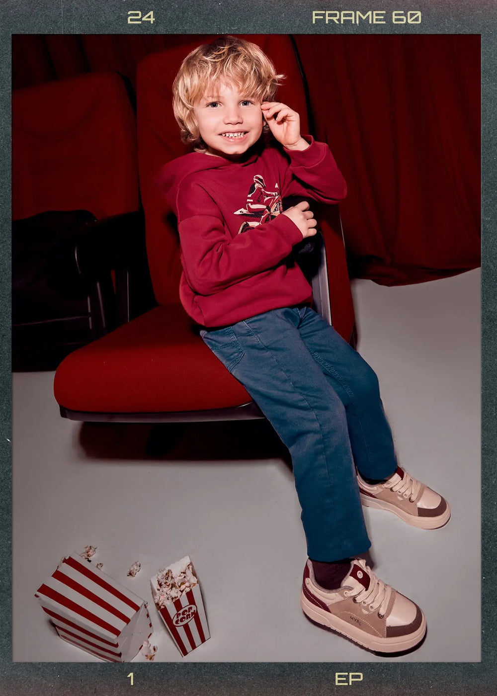 Boy wearing indigo straight-leg pants — lifestyle seated/play pose
