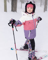 Child wearing black retro flower Teknik snowsuit set – front view on snow
