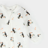 Close-up of ribbed cuffs and toucan print on organic cotton baby sleeper