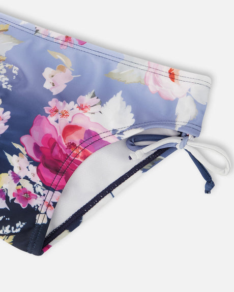 Close-up of a side tie at the hip of the blue rose swimsuit bottoms