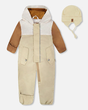 Deux par Deux baby boy mid-season one-piece with hat in beige, front view