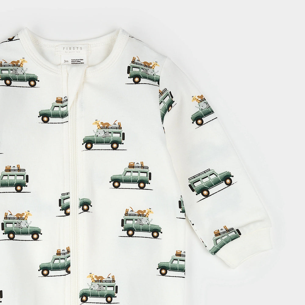 Infant wearing safari jeep print footed sleeper with two-way zipper