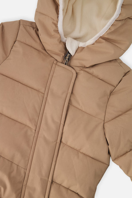Close-up of the beige quilting, front zipper and fleece-lined hood