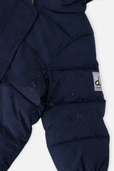 Close-up of the dark blue quilted shoulder and logo tab on the Baby Cloud snowsuit