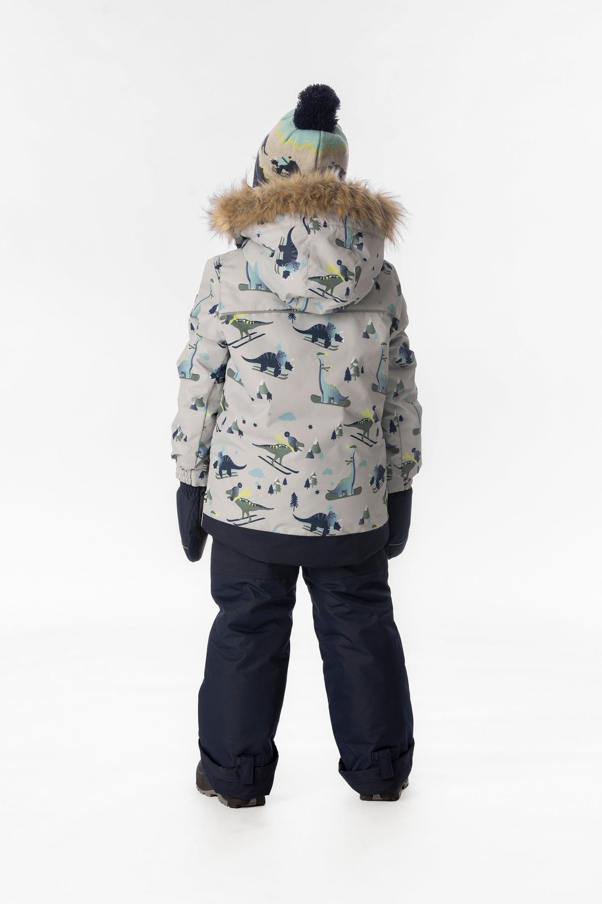 Boy in the grey dinosaur print Deux par Deux DISCOVER snowsuit, back view