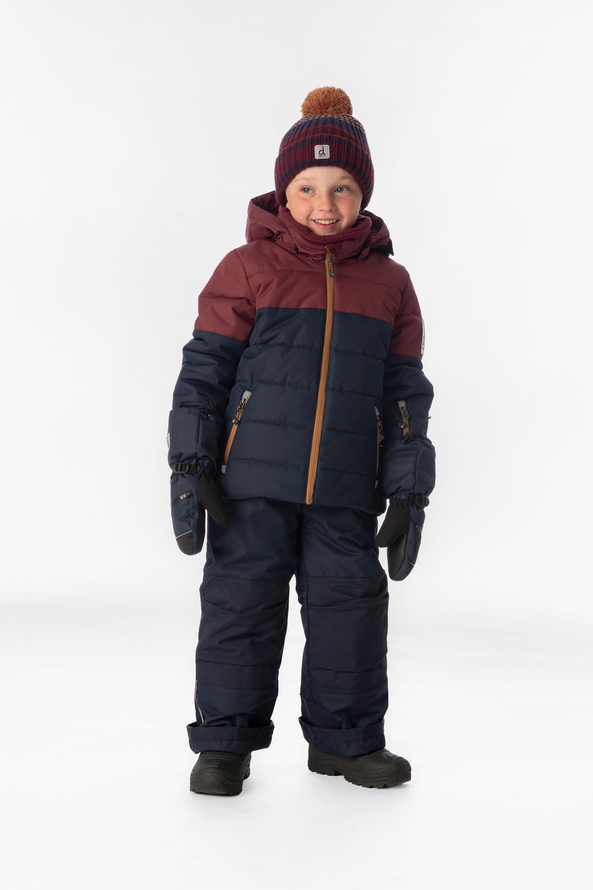 Boy standing in the navy and burgundy Deux par Deux PLAY snowsuit, full-length front view