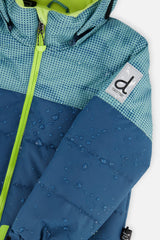 Close-up of the Deux par Deux greyish blue and navy PLAY jacket shell, zipper and logo patch