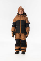 Boy standing in the brown and black Deux par Deux PLAY snowsuit, full-length front view