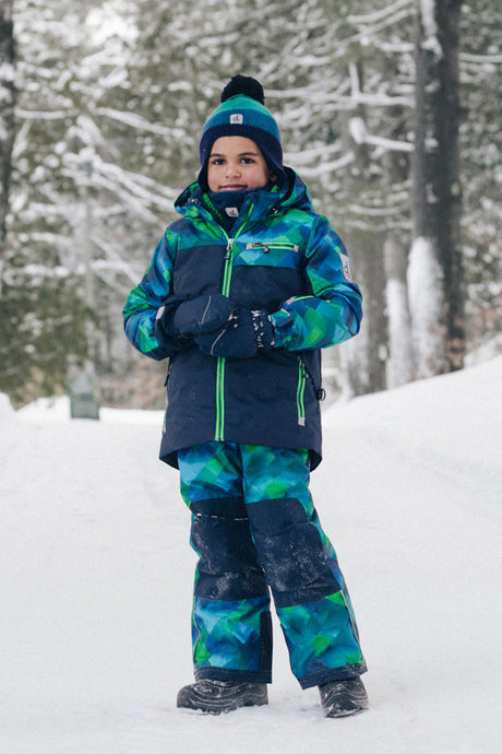 Child wearing the Deux par Deux blue and green checkered PLAY snowsuit, lifestyle photo 3