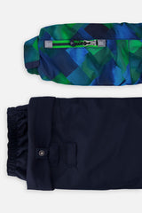 Close-up of the checkered PLAY jacket sleeve ski-pass pocket and the adjustable navy pant hem