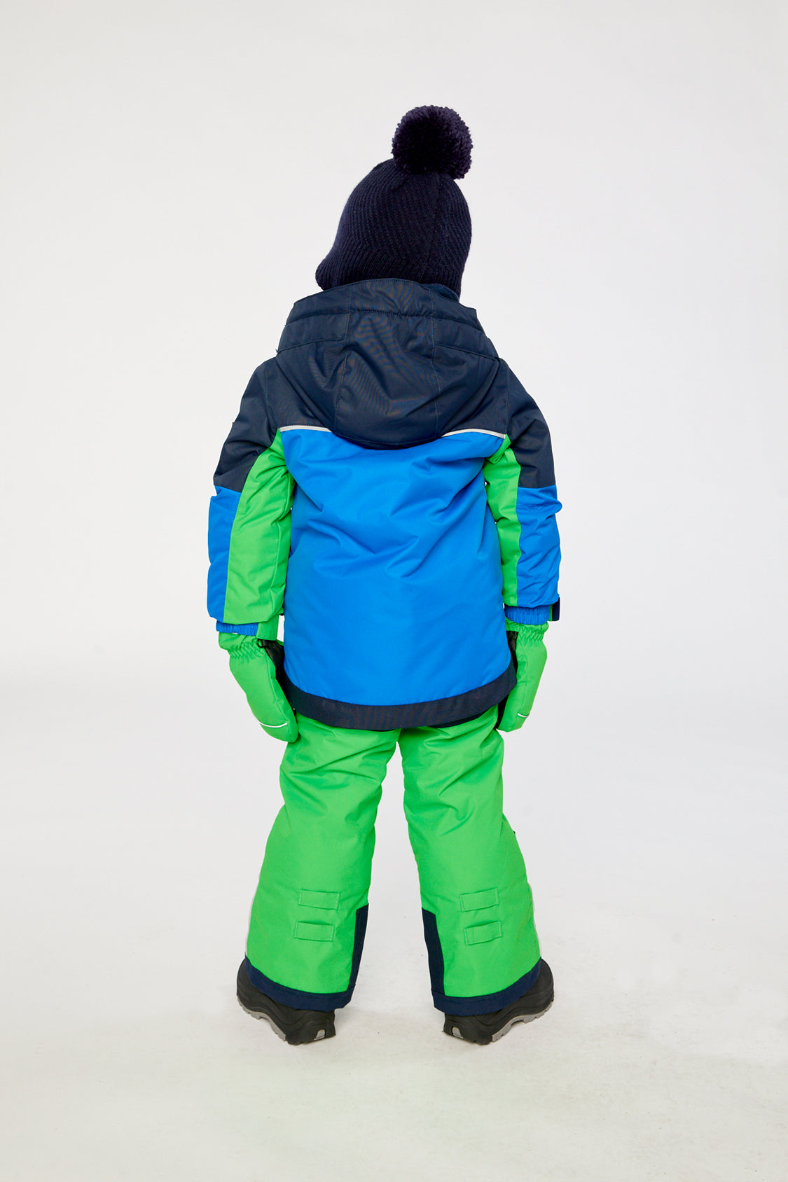 Child wearing the royal blue and green Deux par Deux PLAY snowsuit, lookbook view 3