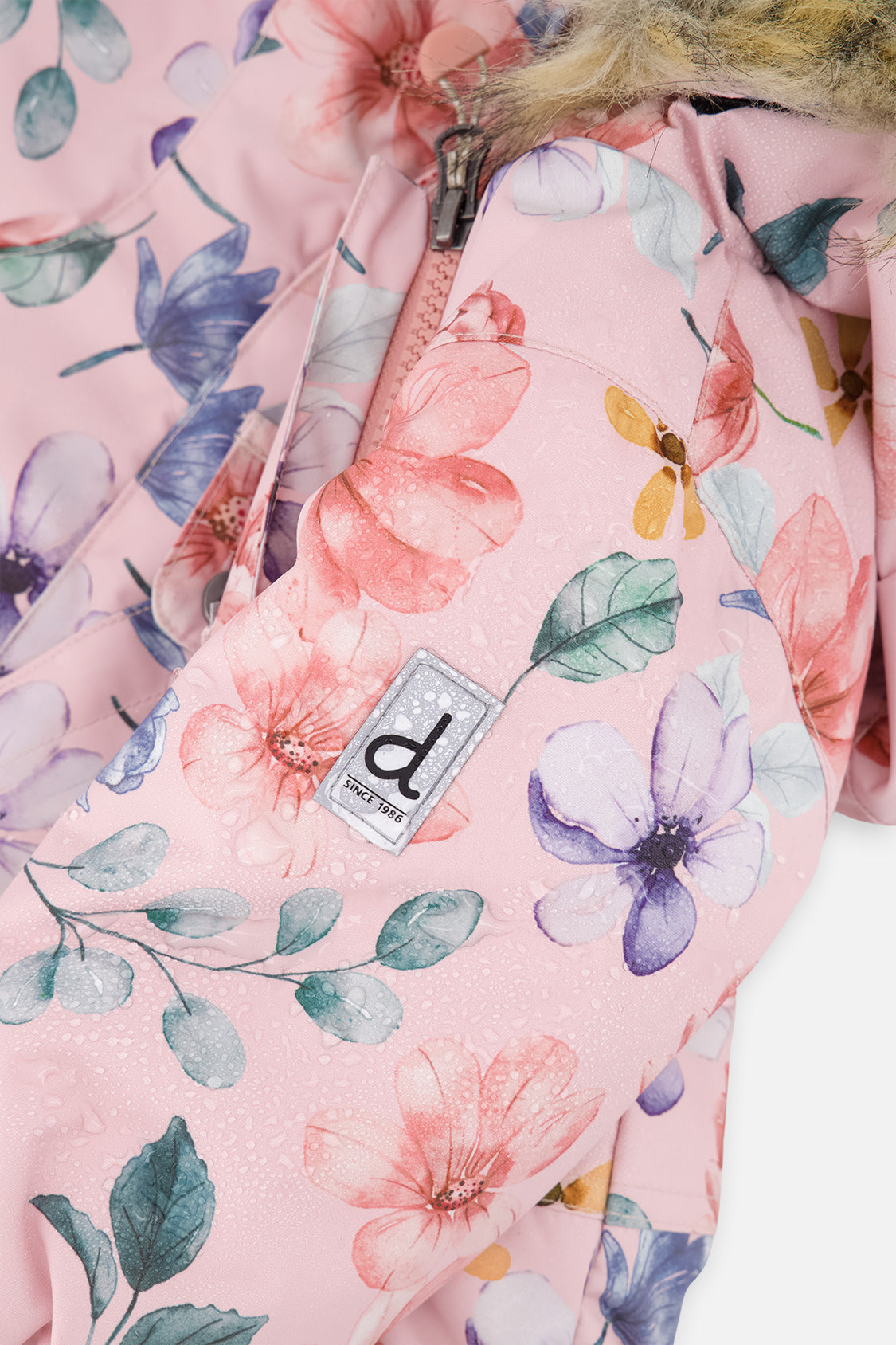 Close-up of the pink floral print fabric with front zipper and Deux par Deux logo