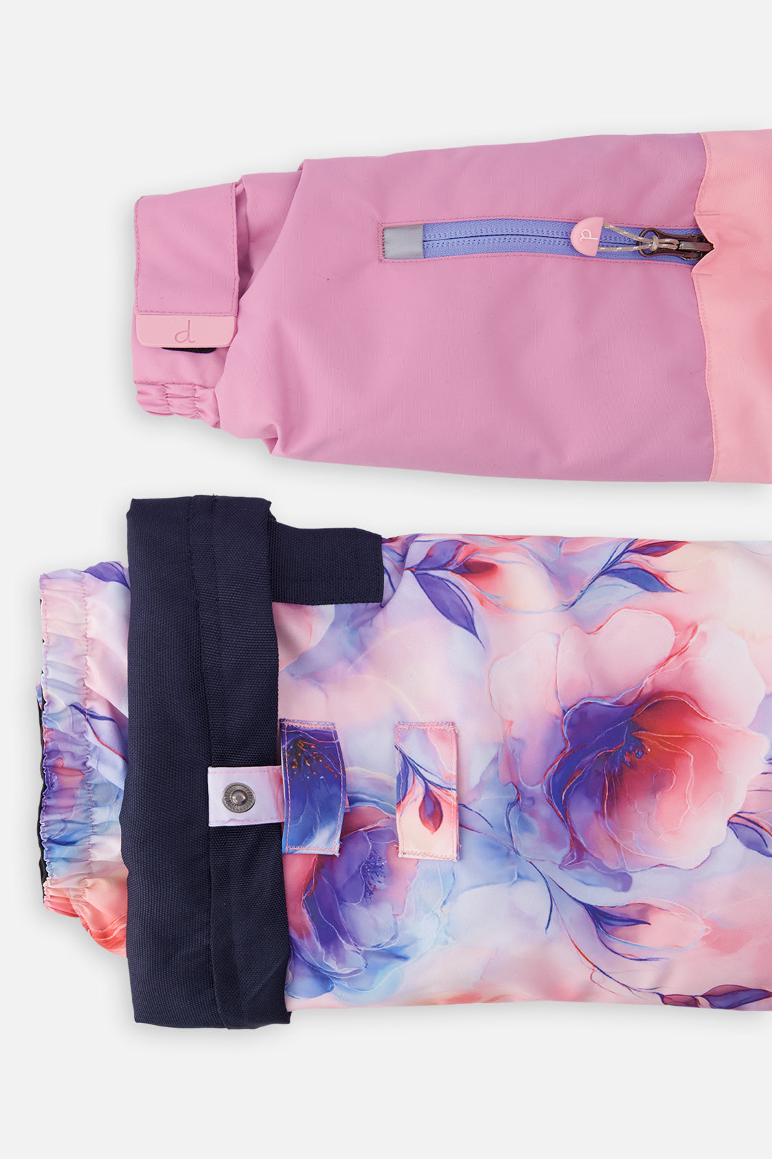Close-up of the colorblock PLAY jacket sleeve pocket and floral pant hem