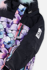 Close-up of the purple floral print, black panel and logo on the PLAY jacket
