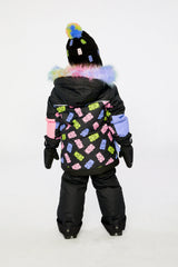 Back view of a girl wearing the black gummy bear print PLAY snowsuit
