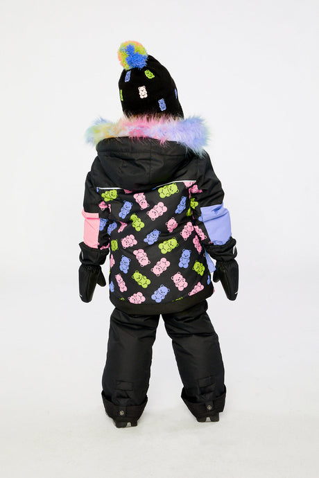 Back view of a girl wearing the black gummy bear print PLAY snowsuit