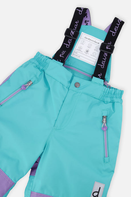 Deux par Deux girls' PLAY snowsuit with diamond-print jacket and turquoise and purple pants, further studio view