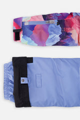 Close-up of the mountain-print sleeve ski-pass pocket and the adjustable blue pant hem