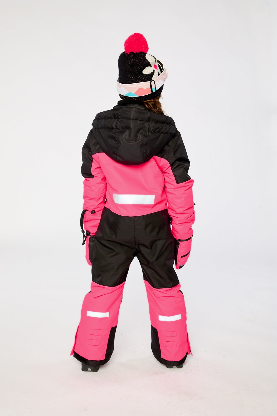 Child wearing the bright pink Deux par Deux Teknik one-piece snowsuit, lookbook photo 3