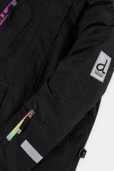 Deux par Deux girls' Teknik snowsuit, black jacket and pink-blue mountain print pants – logo badge close-up