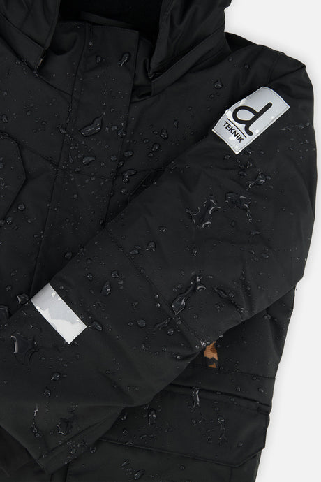 Deux par Deux girls' Teknik two-piece snowsuit, black jacket with leopard print pants – logo badge close-up