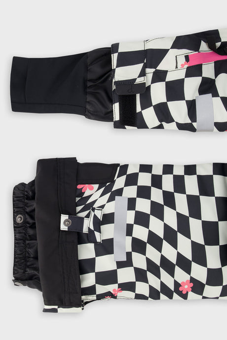 Close-up of the TEKNIK jacket cuff and the adjustable snow pant hem with snap tab