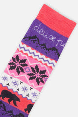 Close-up of a ski sock with snowflake and bear bands below a coral cuff