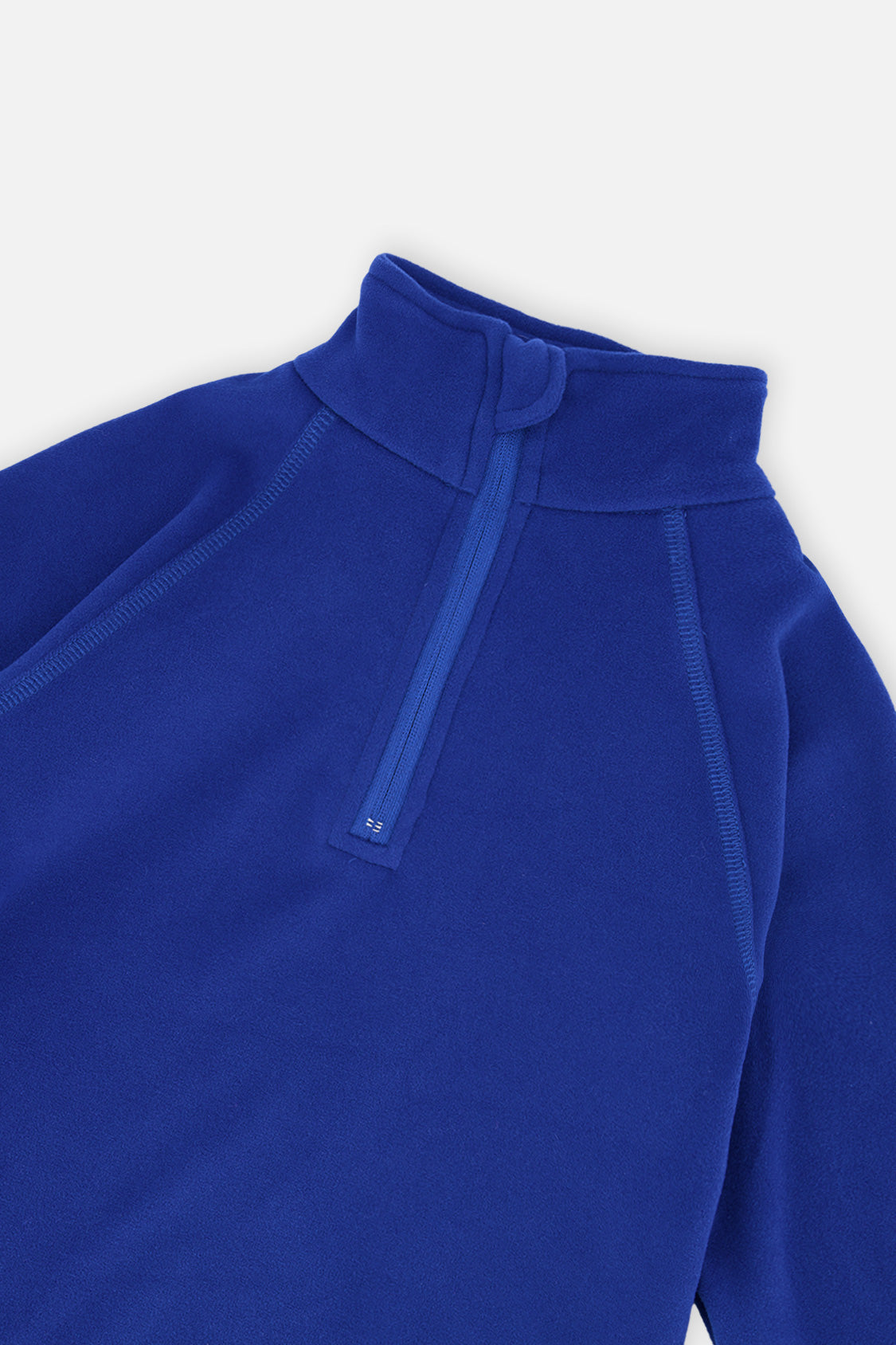 Close-up of the half-zip mock neck and raglan seams on the royal blue thermal underwear top