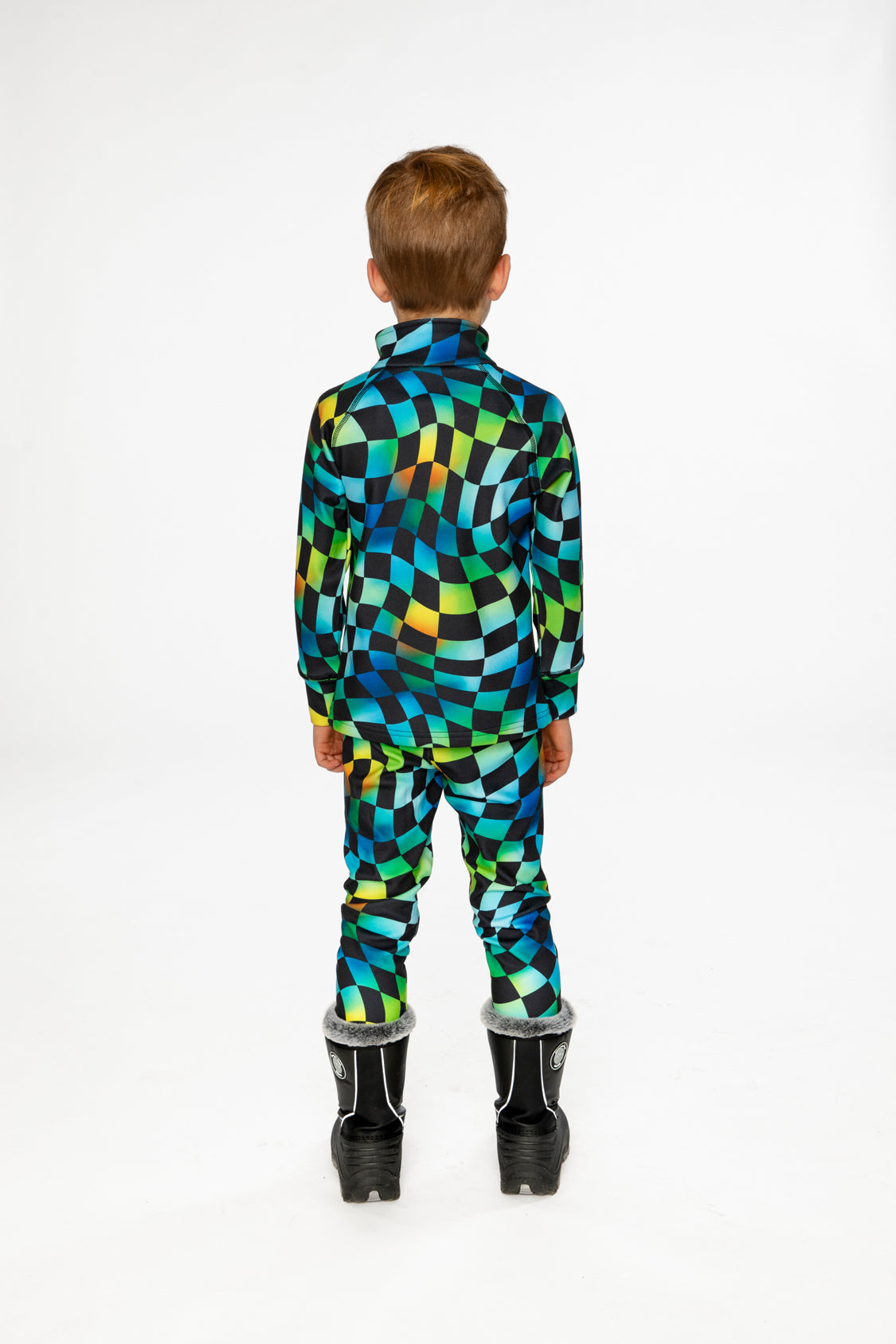 Child wearing the blue checkered Deux par Deux thermal underwear set with black boots, back view
