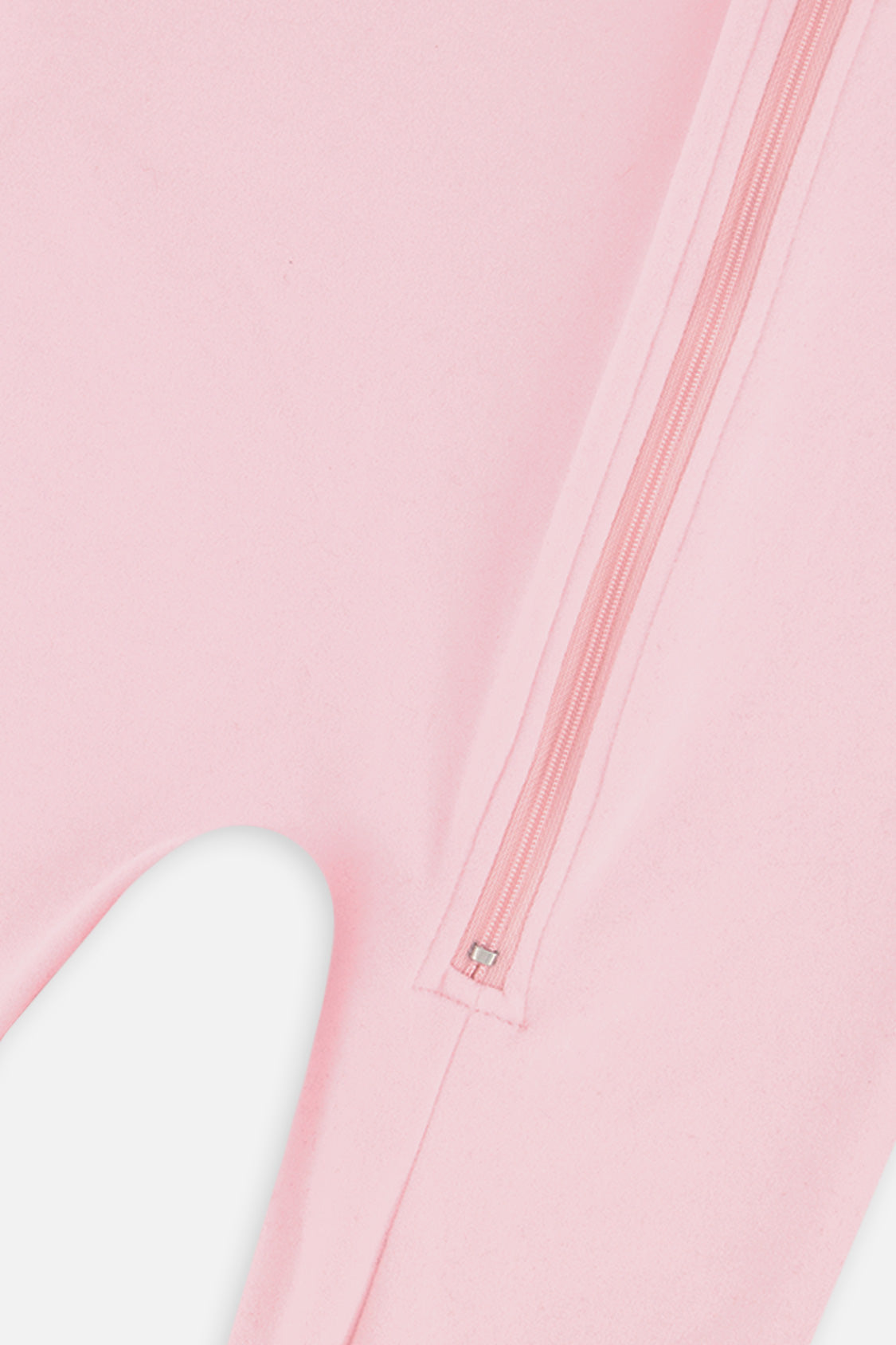 Close-up of the pale pink zipper and soft brushed fabric on the baby one-piece